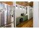 Kitchen features stainless steel fridge, green cabinets, wooden ceiling, and modern appliances at 512 Stratford Dr, Zebulon, NC 27597