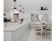Contemporary kitchen featuring white cabinetry, a granite countertop island with seating, and modern pendant lighting at 512 Stratford Dr, Zebulon, NC 27597