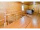 Spacious room with wood paneling, hardwood floors, and a cozy seating area at 512 Stratford Dr, Zebulon, NC 27597