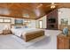 Spacious bedroom featuring wood-paneled ceiling, brick fireplace, and king-size bed at 512 Stratford Dr, Zebulon, NC 27597