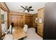 Office area featuring wood paneled walls, ceiling fan, and large desk at 512 Stratford Dr, Zebulon, NC 27597