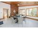 Bright sun room features brick fireplace, wooden ceiling, tile flooring, modern windows, and seating at 512 Stratford Dr, Zebulon, NC 27597