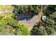 Aerial view of a full-sized tennis court surrounded by trees, offering a private recreational space at 512 Stratford Dr, Zebulon, NC 27597