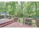 Outdoor deck with a set of stairs leading down to a spacious grassy backyard area at 5319 Memory Ln, Durham, NC 27712