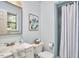 Well-lit bathroom featuring a vanity with a sink, toilet, and a shower with a curtain, offering functionality and style at 5319 Memory Ln, Durham, NC 27712
