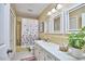 Neat bathroom featuring a vanity with a sink, toilet, and a shower with a curtain, designed for comfort and hygiene at 5319 Memory Ln, Durham, NC 27712