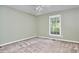 Clean bedroom with carpeted floors, neutral walls, and a window bringing in natural light at 5319 Memory Ln, Durham, NC 27712