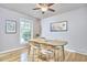 Inviting dining room featuring hardwood floors, modern furniture, and ample natural light from large windows at 5319 Memory Ln, Durham, NC 27712