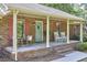 Inviting covered front porch with rocking chairs, perfect for enjoying quiet moments outdoors at 5319 Memory Ln, Durham, NC 27712