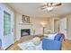 Charming living room featuring a cozy seating arrangement, a fireplace, and a view of the outdoors through a glass-paneled door at 5319 Memory Ln, Durham, NC 27712