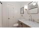 Cozy bathroom features white subway tile, modern vanity with a marble top, and brushed gold fixtures at 5709 Lakehaven Dr, Raleigh, NC 27612