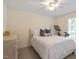 Neutral bedroom with a white queen bed, simple decor, and exercise equipment near the window at 5709 Lakehaven Dr, Raleigh, NC 27612