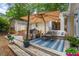 Outdoor deck with cozy seating, a large umbrella, a grill, and string lights for evening ambiance at 5709 Lakehaven Dr, Raleigh, NC 27612
