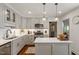 Modern kitchen with stainless steel appliances, gray cabinetry, and quartz countertops at 5709 Lakehaven Dr, Raleigh, NC 27612