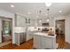 Modern kitchen with stainless steel appliances, gray cabinetry, and quartz countertops at 5709 Lakehaven Dr, Raleigh, NC 27612