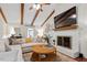 Cozy living room with vaulted ceilings, wood beams, a fireplace, and comfortable seating at 5709 Lakehaven Dr, Raleigh, NC 27612