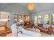 Inviting sunroom with a mix of seating, wood accents, and natural light at 5709 Lakehaven Dr, Raleigh, NC 27612