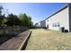 Large backyard with garden bed, privacy fence, and home exterior view at 621 Childsberg Way, Hillsborough, NC 27278