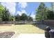 Large backyard with a wood fence, raised garden beds, a patio, and mature trees at 621 Childsberg Way, Hillsborough, NC 27278