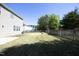 Well-maintained backyard with green grass and raised garden beds near a wooden fence at 621 Childsberg Way, Hillsborough, NC 27278