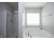 Bright bathroom featuring a soaking tub and a glass-enclosed shower with a tiled floor at 621 Childsberg Way, Hillsborough, NC 27278