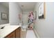 Bright bathroom featuring a wood vanity, toilet, and tub with a patterned shower curtain at 621 Childsberg Way, Hillsborough, NC 27278