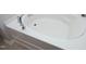 Close up of a white bathtub with chrome fixtures and tiled floors at 621 Childsberg Way, Hillsborough, NC 27278