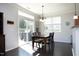 Bright dining area featuring a dark wood table with seating for four and sliding door access to the patio at 621 Childsberg Way, Hillsborough, NC 27278