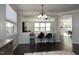 Inviting dining area featuring modern lighting and seamless flow into living spaces at 621 Childsberg Way, Hillsborough, NC 27278