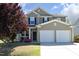 Charming two-story home with a manicured lawn and attached two-car garage at 621 Childsberg Way, Hillsborough, NC 27278