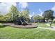Community playground with slides, climbing structures, and green grass at 621 Childsberg Way, Hillsborough, NC 27278