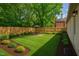 Well-manicured backyard featuring lush greenery, a privacy fence, and outdoor seating at 623 Massey Ave, Durham, NC 27701