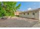 Charming backyard featuring a gravel patio, stone retaining wall, and lush landscaping at 623 Massey Ave, Durham, NC 27701