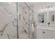 Bathroom showcasing a glass-enclosed shower with marble tiling and a double sink vanity at 623 Massey Ave, Durham, NC 27701