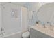 Charming bathroom with blue wallpaper, decorative mirror, and tub with shower curtain at 623 Massey Ave, Durham, NC 27701