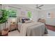 Cozy main bedroom features a ceiling fan, natural light, and neutral decor at 623 Massey Ave, Durham, NC 27701