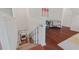 Hallway with hardwood floors, laundry area, and staircase leading to lower level at 623 Massey Ave, Durham, NC 27701