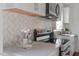 Updated kitchen with stainless steel appliances, stylish backsplash, and plenty of counter space at 623 Massey Ave, Durham, NC 27701