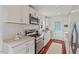 Well-lit kitchen boasts stainless steel appliances, white cabinets, and chic subway tile backsplash at 623 Massey Ave, Durham, NC 27701