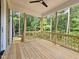 Exterior view of back porch surrounded by trees and featuring wood decking and railing at 629 Conover Rd, Durham, NC 27703