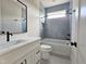 Bathroom featuring a vanity, a mirror, a tub and shower combination with light blue tile surround at 629 Conover Rd, Durham, NC 27703