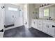 Modern bathroom featuring a double vanity with black hardware, a tiled shower with a glass enclosure at 629 Conover Rd, Durham, NC 27703