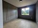 Bedroom with a large window, wood floors, dark gray trim, and a custom wall at 629 Conover Rd, Durham, NC 27703