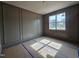 Bedroom with custom dark-gray paneled walls and large window providing natural light at 629 Conover Rd, Durham, NC 27703