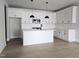 Modern kitchen featuring white cabinets, subway tile backsplash, and a kitchen island with pendant lighting at 629 Conover Rd, Durham, NC 27703