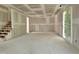 Unfinished living room with stairway, drywall and door to the outside at 629 Conover Rd, Durham, NC 27703
