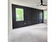 Spacious main bedroom with a striking black accent wall and large windows offering a pleasant view at 629 Conover Rd, Durham, NC 27703