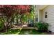 Backyard view with patio, steps, and mature trees offering a serene outdoor retreat at 6509 Virgilia Ct, Raleigh, NC 27616