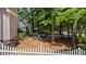 Backyard with fire pit and seating, enclosed by a white picket fence at 6509 Virgilia Ct, Raleigh, NC 27616