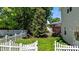 Lush backyard with green grass and a white picket fence for a charming outdoor space at 6509 Virgilia Ct, Raleigh, NC 27616